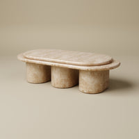 Marble coffee table with cylindrical base on a beige background